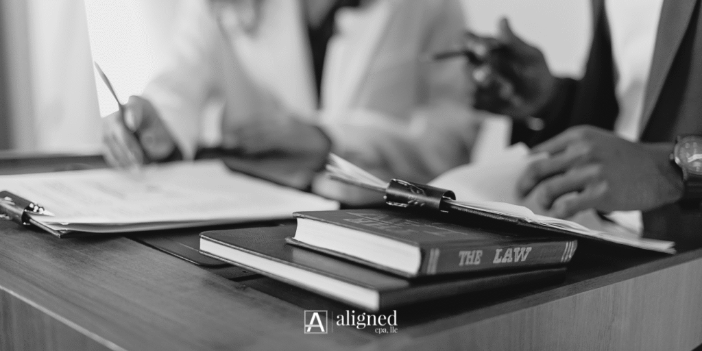 Attorney reviewing trust accounting and operating accounting records with financial reports to maintain IOLTA compliance for a small law firm.