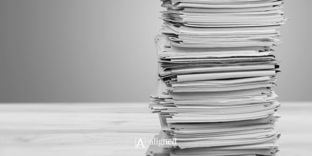 Law firm owner reviewing bookkeeping backwork, financial reports, and year-to-date accounting records